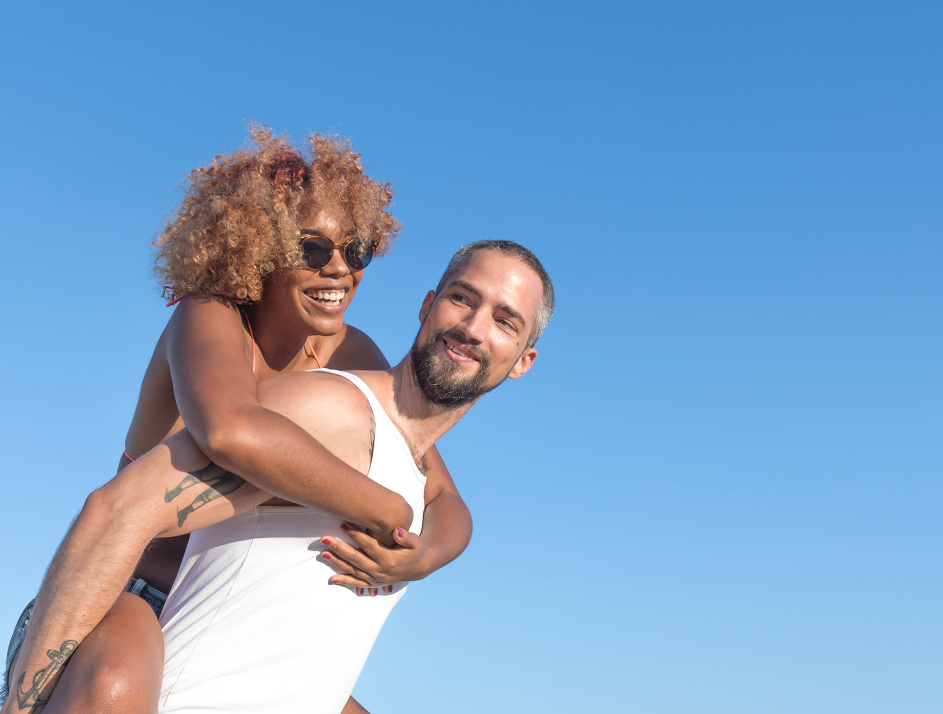 Happy couple piggyback riding
