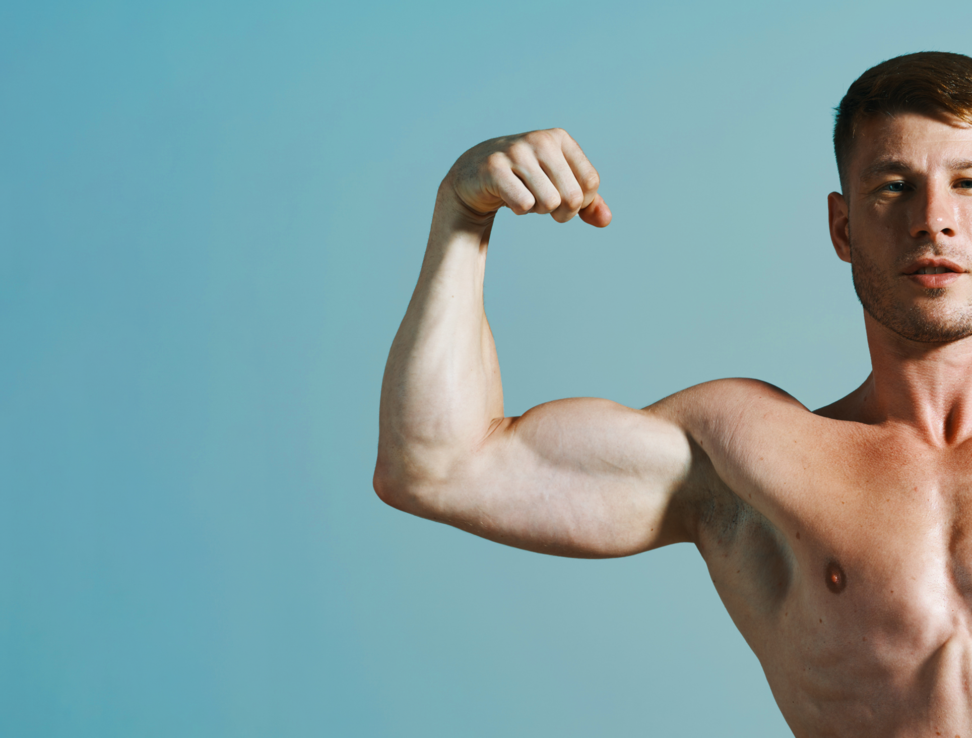Strong man holding up his arms